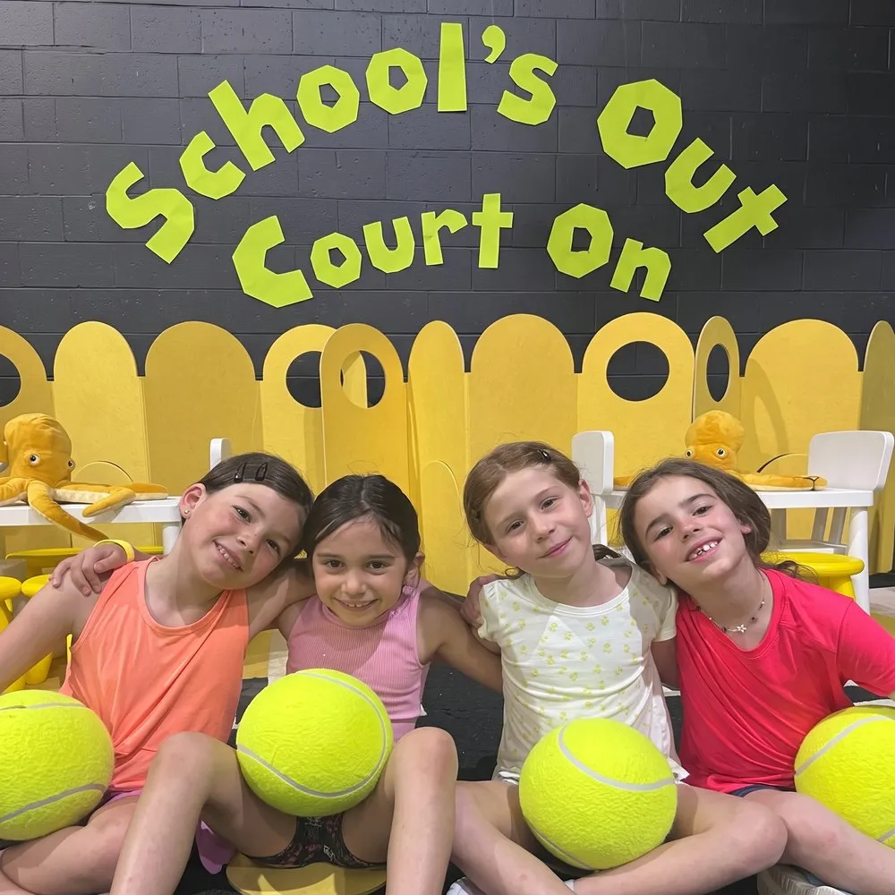 School's Out Courts On PA Day kids camp at The District with children holding oversized tennis balls