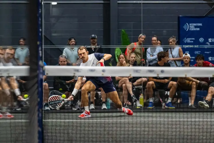 Team USA player stretches for a low volley in front of a packed gallery at The District
